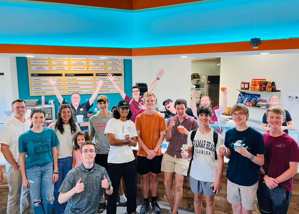 Image of Plano Senior High Band directors and students at Local Creamery, enjoying ice cream during a spirit night. 