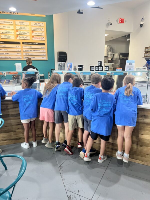 Image of students at Local Creamery looking at the ice cream selection during a field trip.