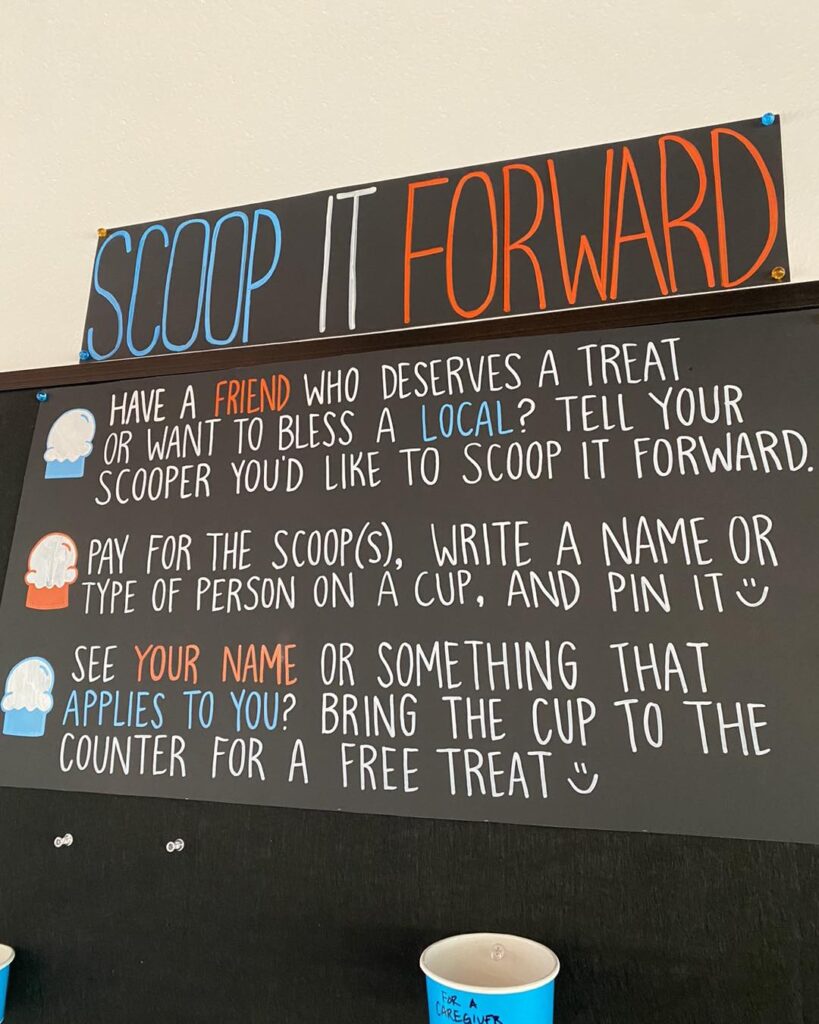 Image of Local Creamery's Scoop it Forward chalk board describing opportunities to bless others with ice cream.